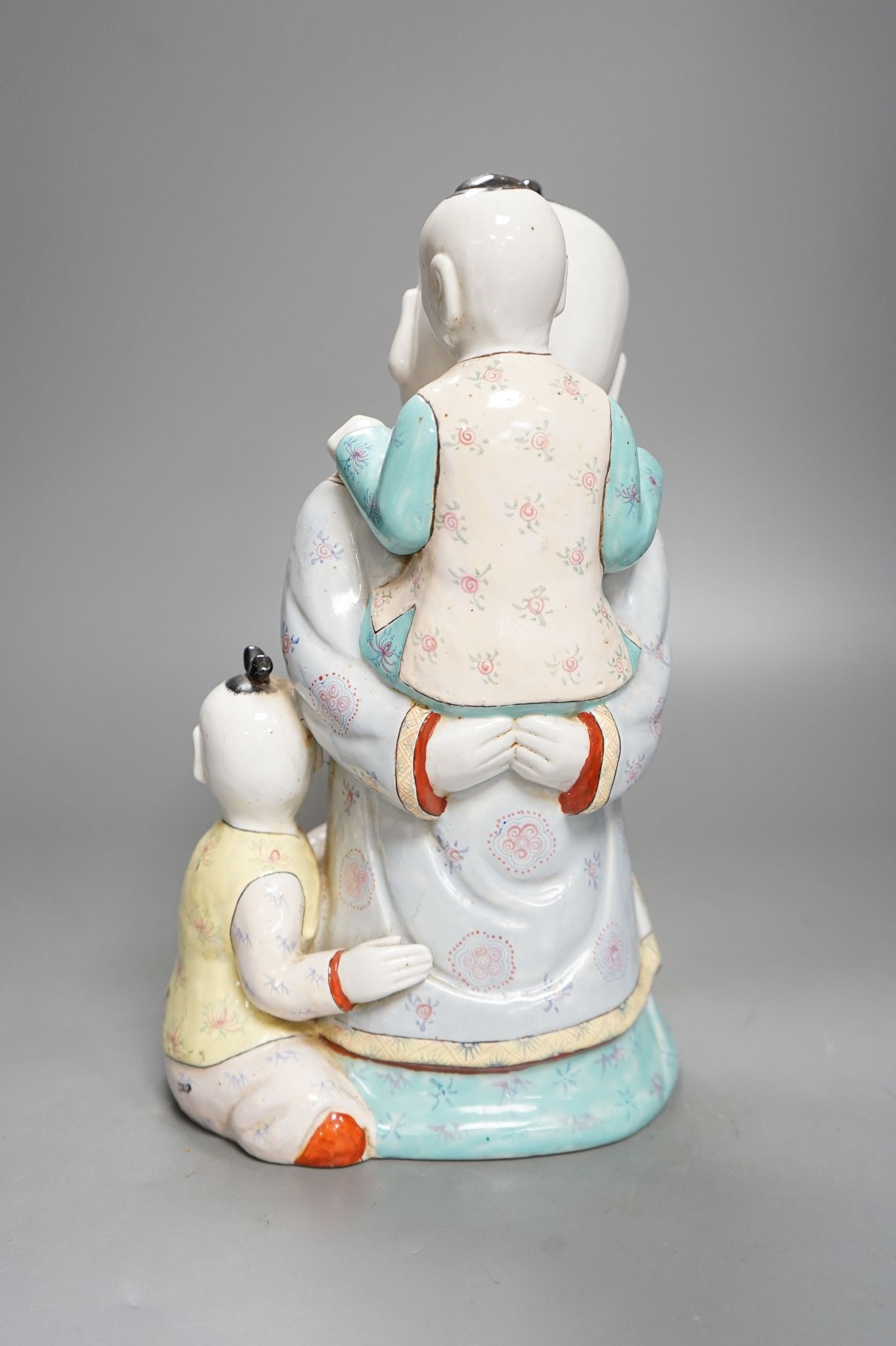 A large Chinese enamelled porcelain boys group, 31cm